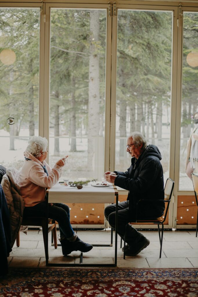elderly-couple-eating-at-table-in-restaurant